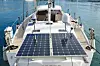 Solar charging batteries aboard a sail boat. Photovoltaic panels renewable eco energy. Genoa, Italy - April 2019