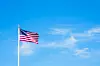 American flag on pole with blue sky