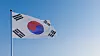 the flag of South Korea in the wind against the blue sky.
