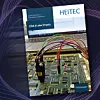 Cover des Heitec-Whitepapers mit Foto einer verdrahteten Leiterplatte vor einem Laptopbildschirm, alles vor einem dunklen Hintergrund mit violetten Akzenten