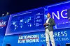 Dr. Florian Weig, Senior Vice President Purchasing & Supplier Network Digital bei der BMW Group, steht auf der Bühne des 30. AUTOMOBIL-ELEKTRONIK KONGRESSES 2026 in Ludwigsburg und hält einen Vortrag zur Zukunft der automobilen Wertschöpfungskette. Im Hintergrund ist eine große Präsentationsfolie mit dem Titel „BMW’s Supply Chain for Digital and Electronics“ zu sehen. Die Folie zeigt eine Weltkarte mit vernetzten Lieferstandorten und Kennzahlen zur BMW-Lieferkette, darunter rund 4.600 weltweite Lieferantenstandorte, etwa 260 direkte Lieferanten, rund 9 Milliarden Euro Einkaufsvolumen im Jahr 2025 sowie 259 Halbleiterlieferanten. Rechts auf der Bühne erscheint Weig zusätzlich auf einer großen Leinwand im Close-up. Die blau ausgeleuchtete Bühne trägt das Branding des 30. AUTOMOBIL-ELEKTRONIK KONGRESSES mit dem Datum 16. und 17. Juni 2026. Das Bild zeigt einen Fachvortrag zu BMW, digitaler Lieferkette, Elektronikbeschaffung, Halbleitern, Software-defined Vehicles, Regulierung, KI, Open Source, Catena-X, geopolitischen Risiken, resilienten Lieferketten und der Zukunft der Automotive Value Chain.