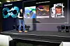 Dr. John Linford, Director of Industrial Engineering at NVIDIA auf einer Bühne vor mehreren großen Displays mit technischen Visualisierungen und Produktbildern.