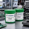 Zwei grüne Dosen Stannol Solder Paste stehen auf einer Produktionsanlage.