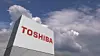 Logo of TOSHIBA on a stand against cloudy sky, editorial 3D rendering