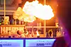 Feuriger Showact an der Bar: Der Barkeeper beeindruckt das Publikum mit einer spektakulären Feuerperformance und außergewöhnlichen Cocktailkreationen.