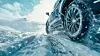 Close up photo of car driving in snow blizzard with winter tires in harsh winter conditions
