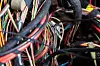 A cable of matted wires of different colors with connectors in the electrical wiring of the car. Internet line in the work of the provider.