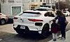 Robotaxi von Waymo an einer Straße. Eine Frau und ein Kind wollen gerade einsteigen.
